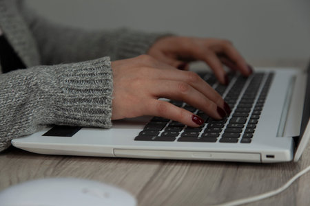 woman working in computer keyboard on the desk