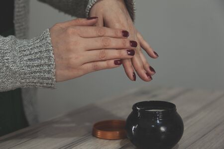 woman hand cream on gray wall backgroundの写真素材