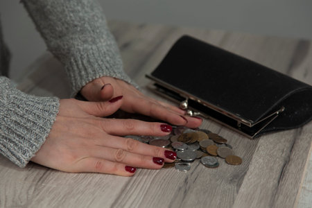 woman hand wallet with coins on the desk