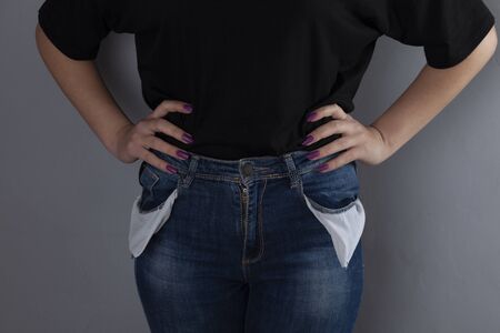 woman  hand empty pocket on the grey backgroundの写真素材