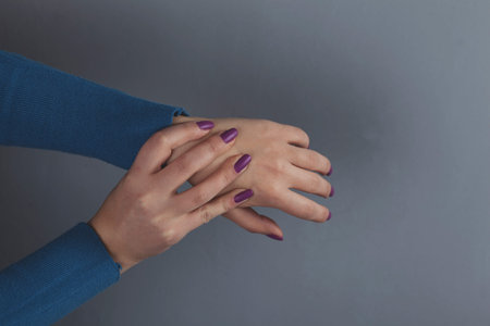 woman ache finger on the dark background