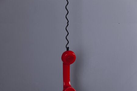 red vintage phone on the dark wall backgroundの写真素材