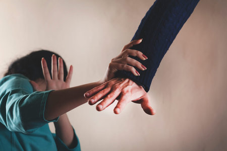 angry man beat sad woman on darkbackground