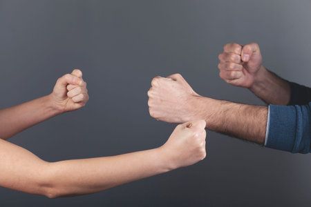 angry woman and man  fists on dark backgroundの写真素材