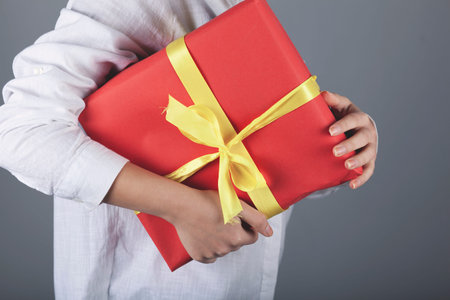 woman hand beautiful gift box in face の写真素材