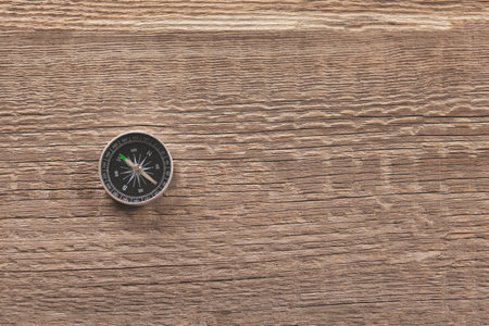 compass on the brown wooden  table background
