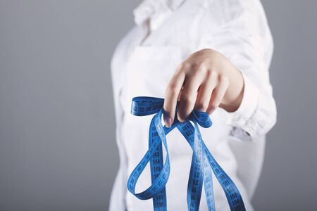 young woman hand meter on grey backgroundの写真素材