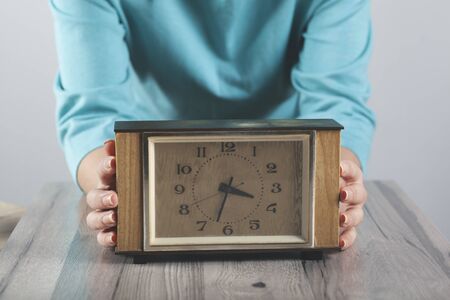 woman hand clock on the tableの写真素材