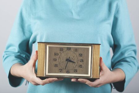 woman hand clock on the on gray backgroundの写真素材
