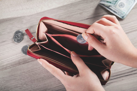 young woman hand holding  coin with wallet 