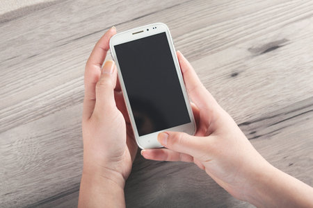 woman hand smart phone on the desk