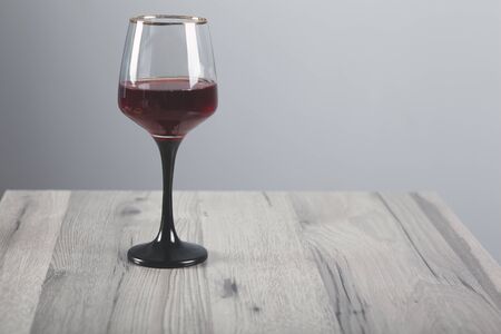 glass of red wine on the wooden tableの写真素材