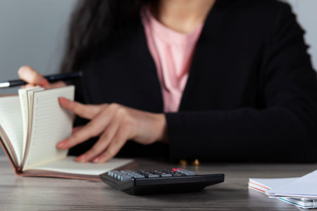 woman hand pen with notepad on the working desk