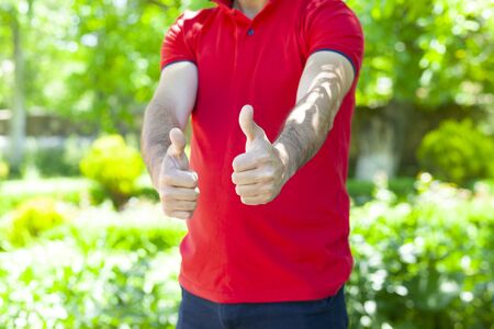 man hand okay sign in street backgroundの写真素材