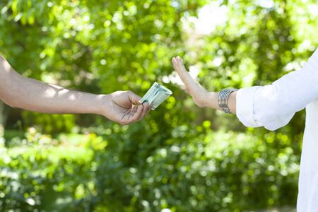 young woman hand stop sign in moneyの写真素材