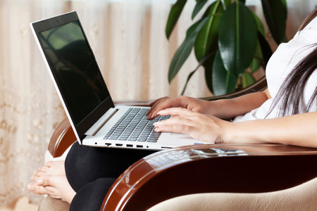 woman  working in computer on armchair