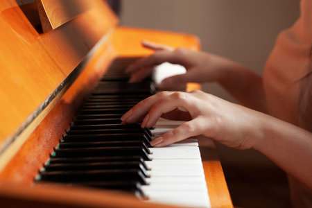 the young woman plays the brown piano