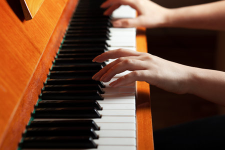 the young woman plays the brown piano