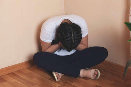 sad baby hand on face on groundの写真素材