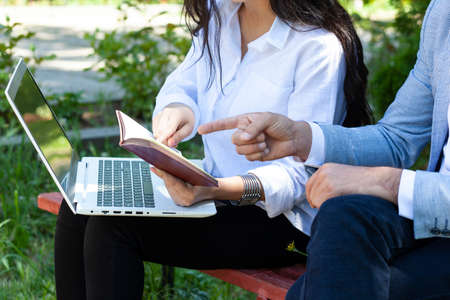 team working in computer in the park backgroundの写真素材