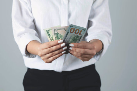 A young woman is holding money in her hands