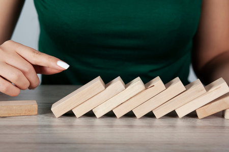 woman hand wooden cubes on table