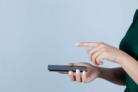 woman hand phone with touching on gray background
