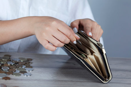 sad woman hand wallet with money on desk