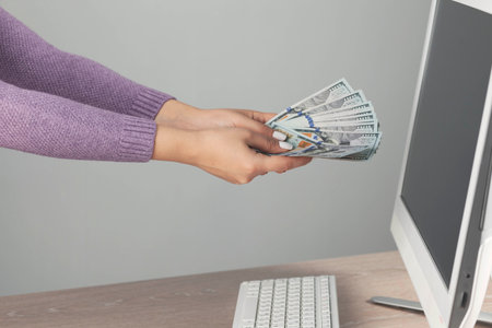 happy woman hand money in desktop background