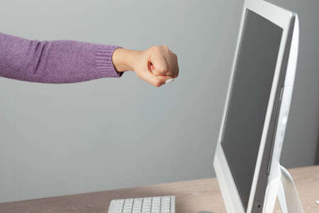 happy woman hand yes sign with computer on deskの写真素材