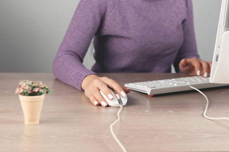woman hand holding computer mouse. Isolated on white background