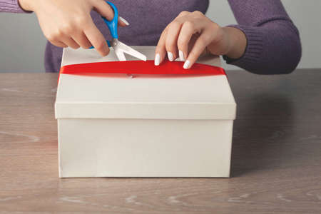 woman hand scissors and tape on tableの写真素材