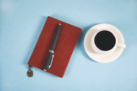 Coffee with notepad and pen on the tableの写真素材