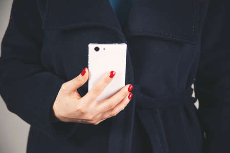 woman hand phone with touching on gray backgroundの写真素材