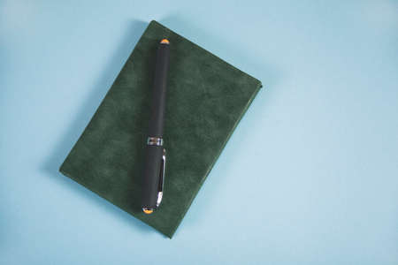 notepad and pen on the tableの写真素材