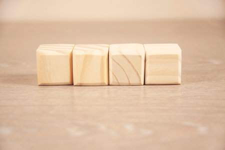 wooden Architectural cubes on table on brick wall backgroundの写真素材