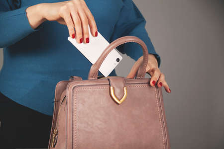 woman hand phone with bag pocketの写真素材
