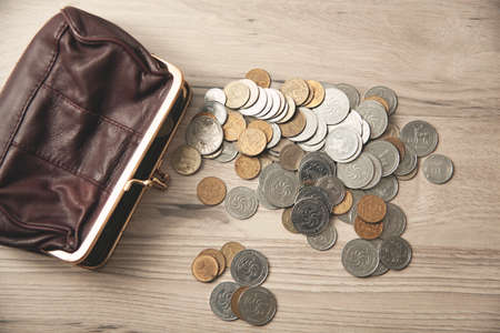 wallet with coins on the desk backgroundの写真素材