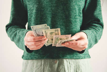 young woman hand money on pink backgroundの写真素材