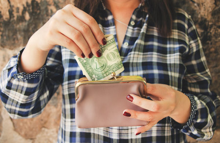 woman hand wallet and money in street