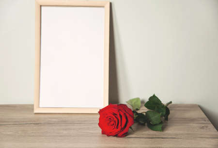 red rose and photo frame on the tableの写真素材