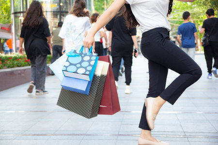 woman hand colorful shopping bags in the street