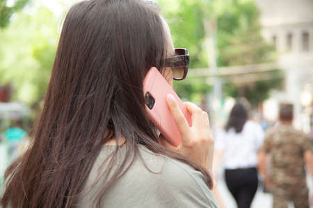 woman hand bag and phone on the stairsの写真素材