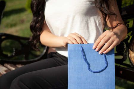 woman hand colorful shopping bags in the streetの写真素材