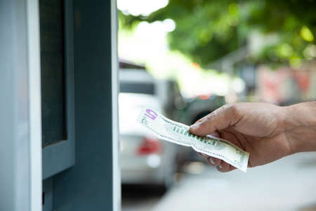 Young man take the money from atm machineの写真素材