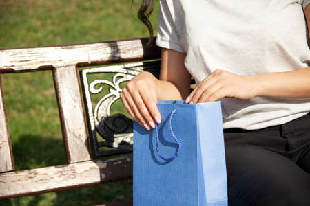woman hand colorful shopping bags in the streetの写真素材