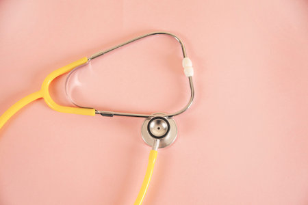 medical stethoscope on pink table backgroundの写真素材