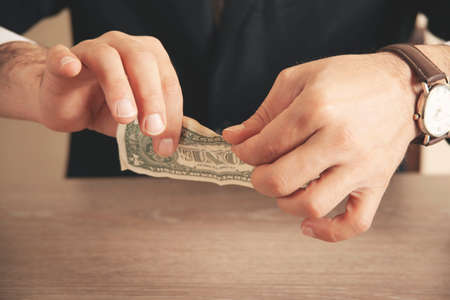 The man tore the moneyの写真素材