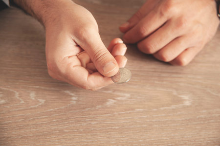 man hand coins on document on the desk