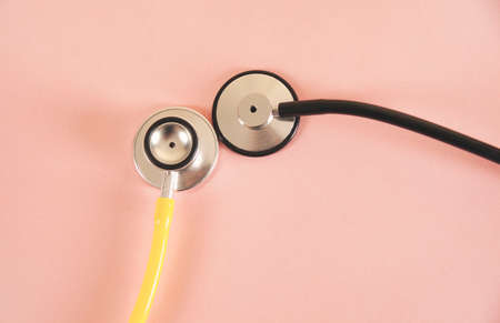medical stethoscope on pink table backgroundの写真素材